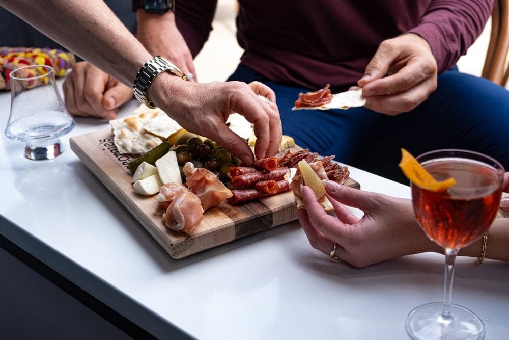 Guests sharing a charcuterie board at Georgie's Social House in Lexington, KY
